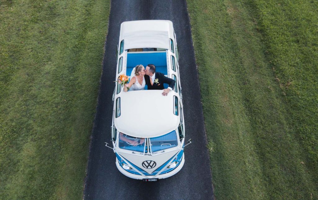 aerial drone photograph of bride and groom in deluxe kombi