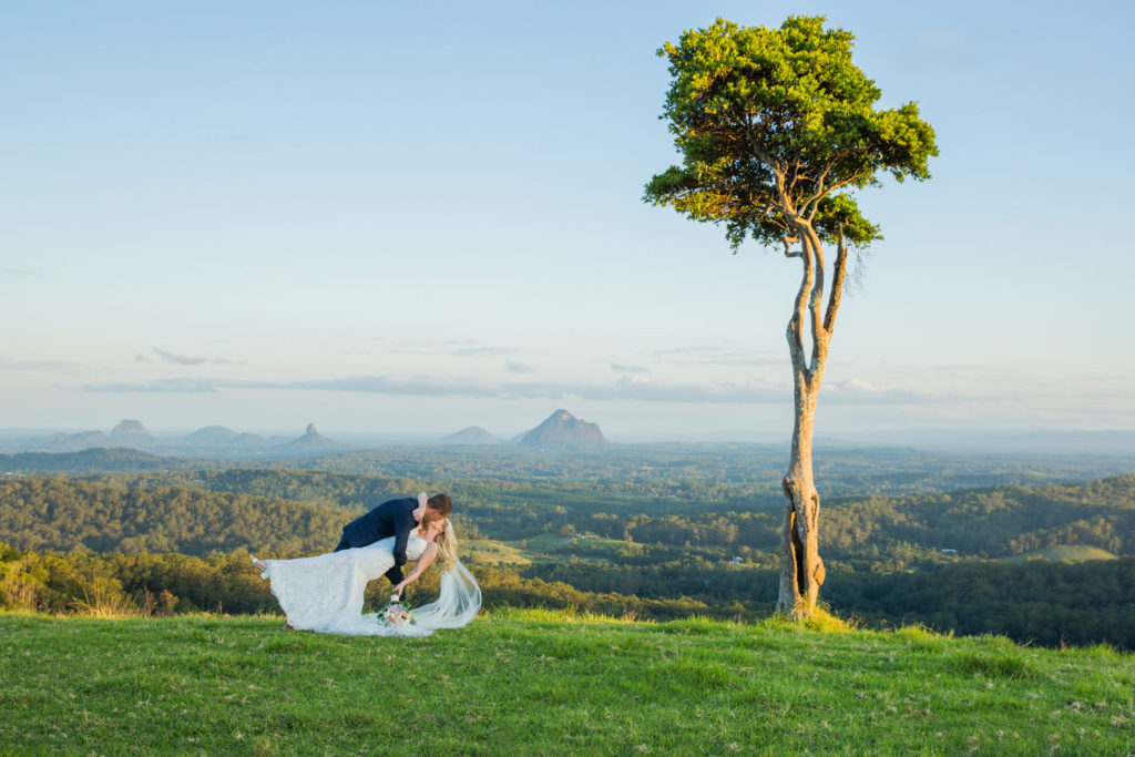 bridal couple kiss under iconic tree on sunshine coast hinterland