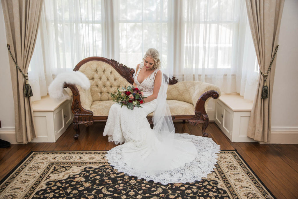 bridal preparation photo of bride with lace train on wedding dress