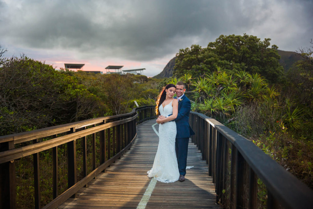bride and groom with mount coolum sunshine coast on rainy day