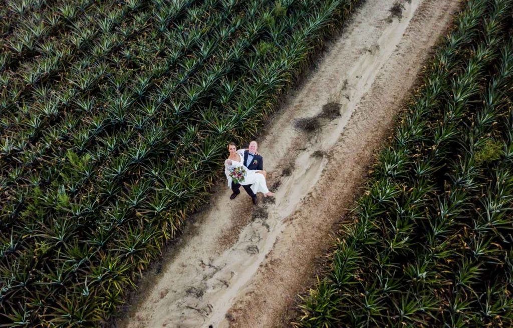 fun bride and groom in aerial drone shot