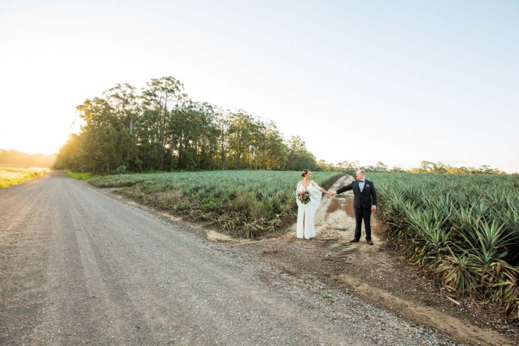 fun bride and groom in sunshine coast fields