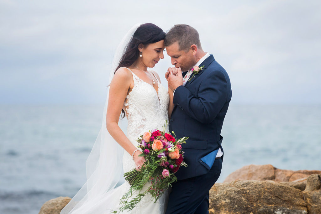 loving bride and groom on cloudy day