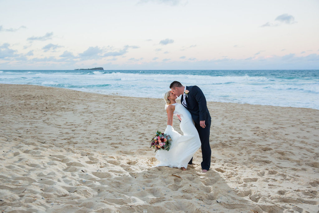 photo of bride and groom at mudjimba-marcoola beach sunshine coast at sunset