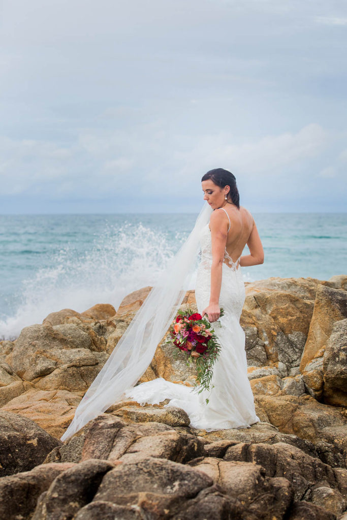 photo of bride with surf in rainy weather