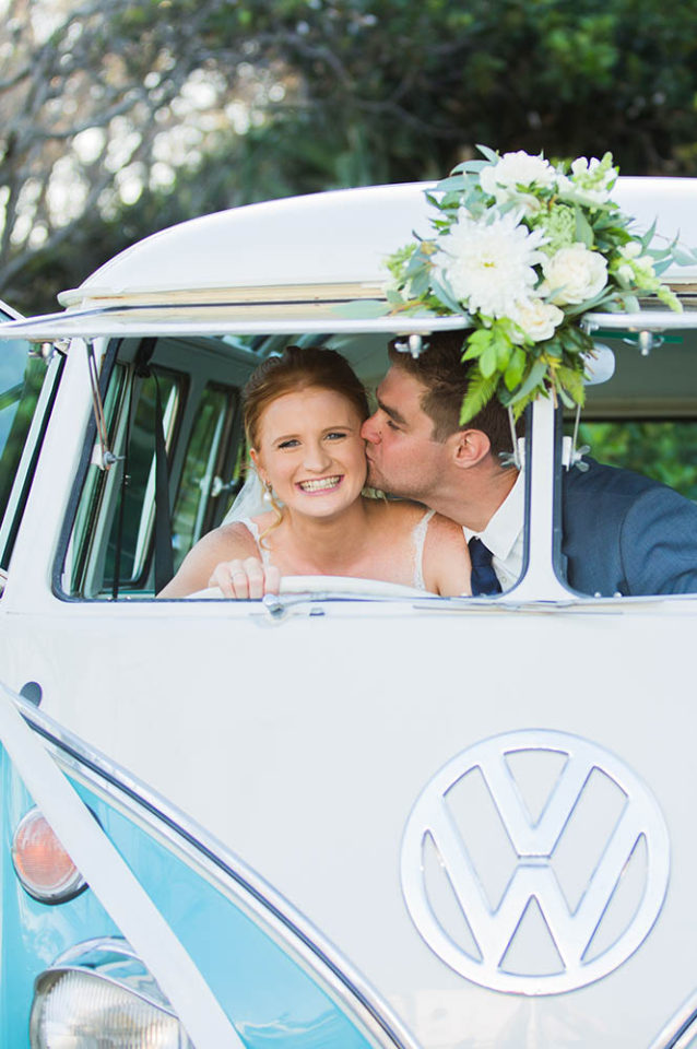 photo of cute kiss in deluxe kombi beach wedding