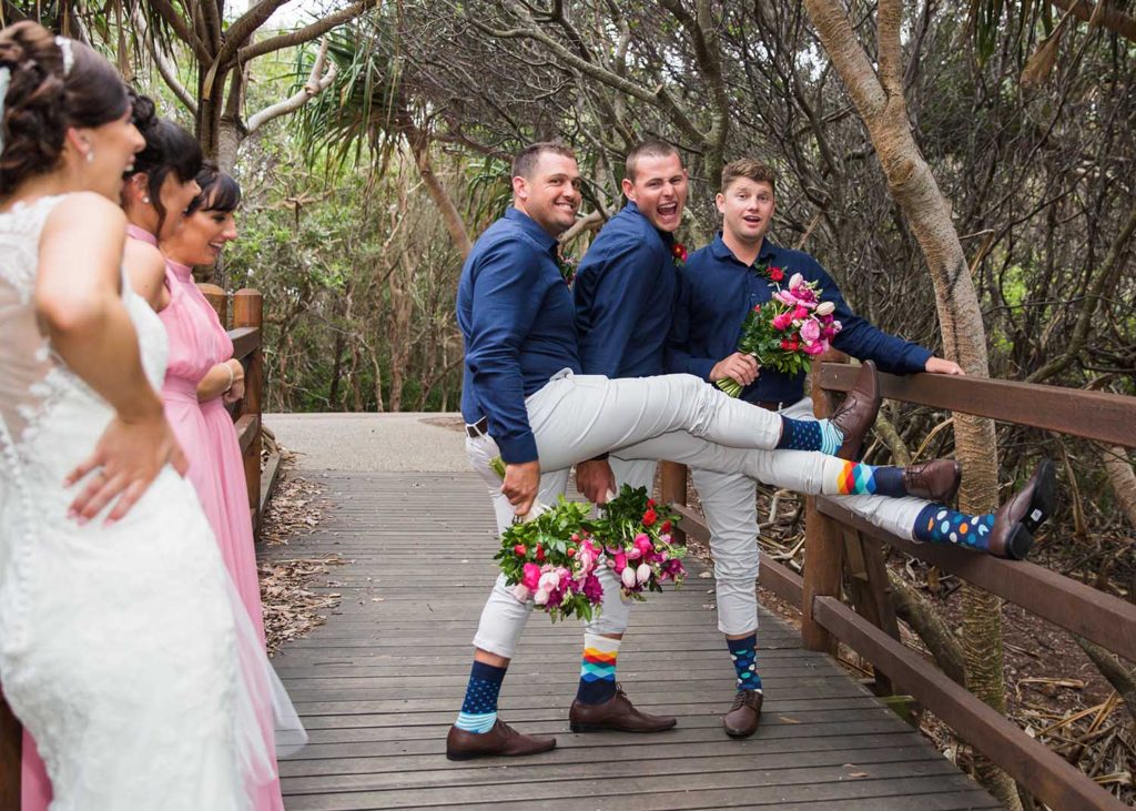 photo of fun bridal party on beach boardwalk