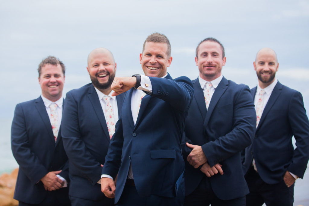 photo of happy groomsmen at beach