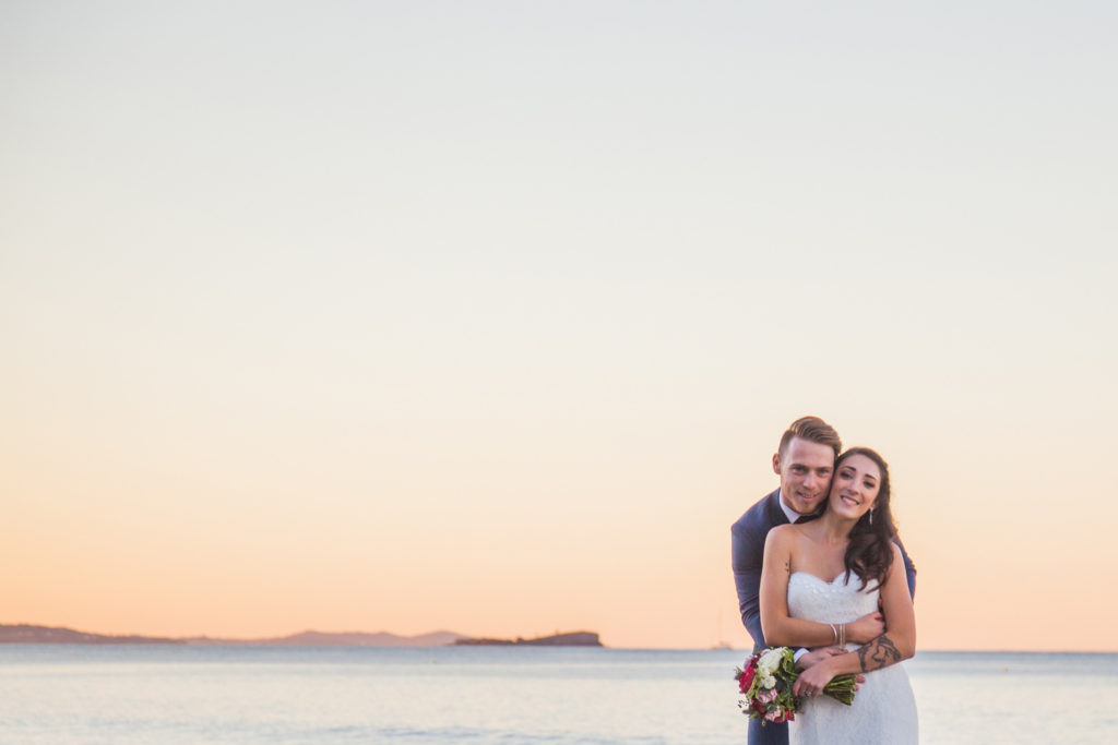 photograph of wedding couple at sunset by ocean