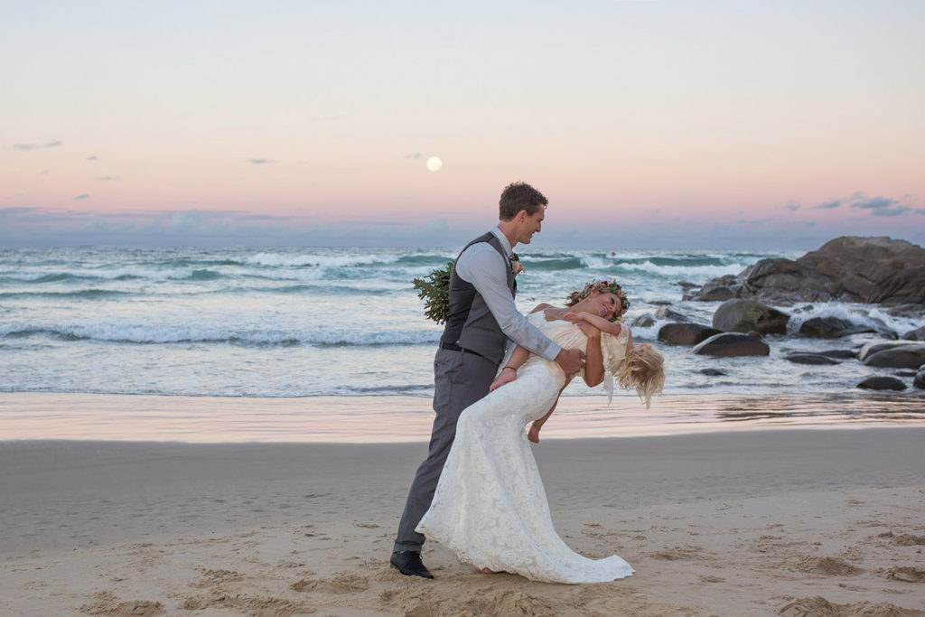 photograph of wedding couple beachside at sunset