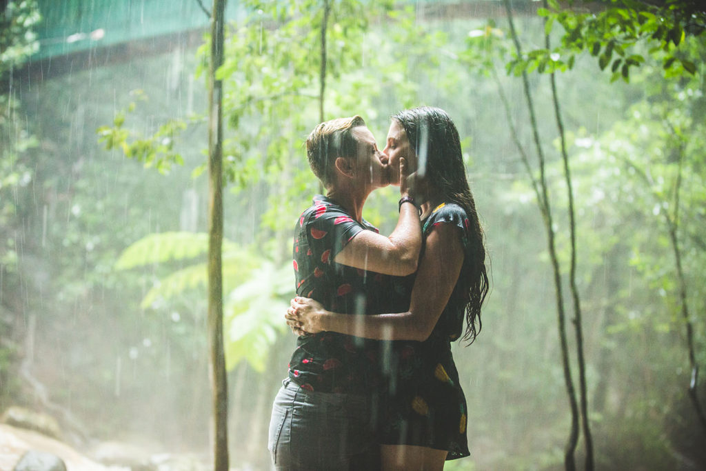 down to earth couple embrace in rain